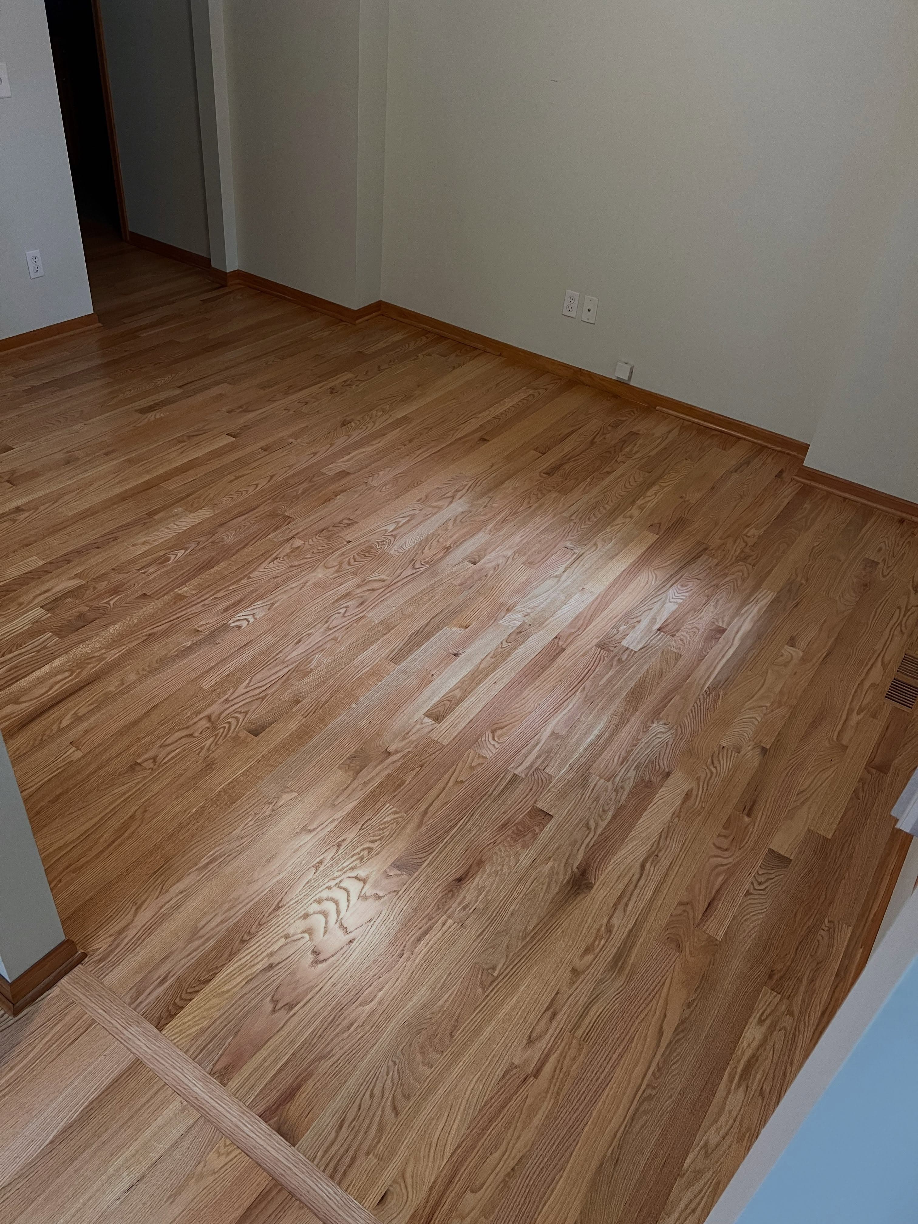 Finished room with medium-tone wood plank flooring