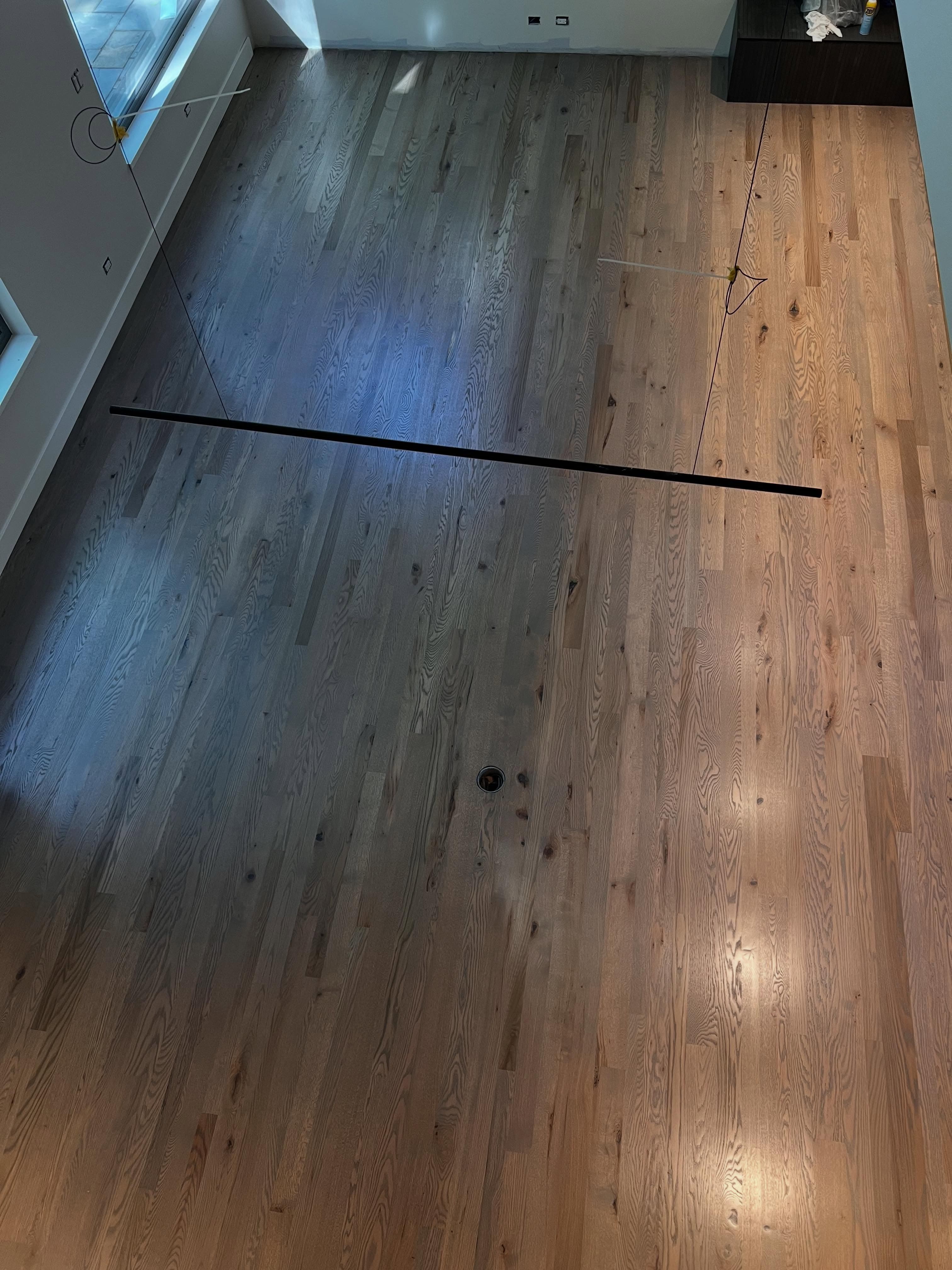 Hardwood floor with multi-colored wood tones and reflective finish