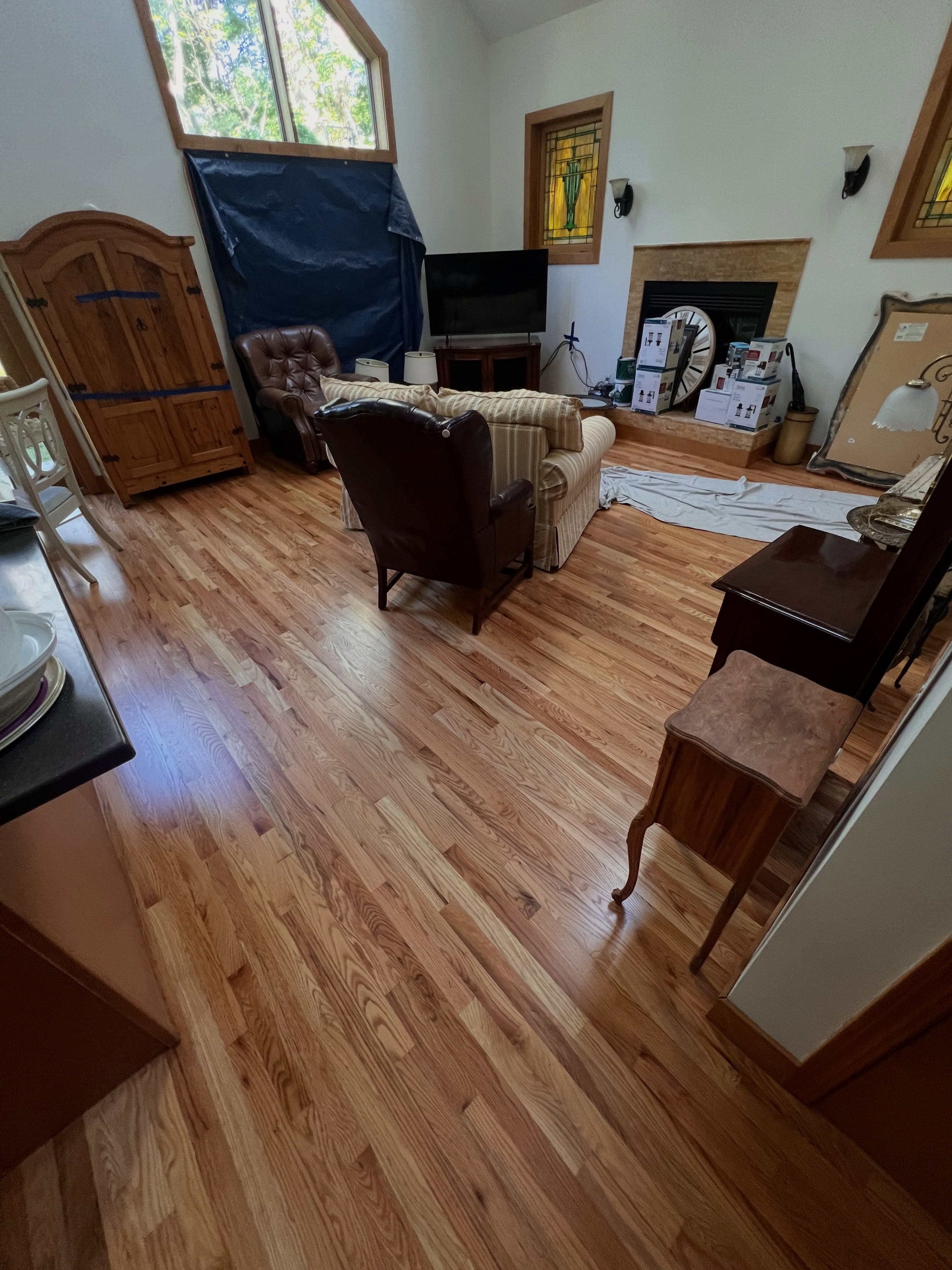 Finished residential room with blonde wood-look vinyl flooring throughout an open floor plan