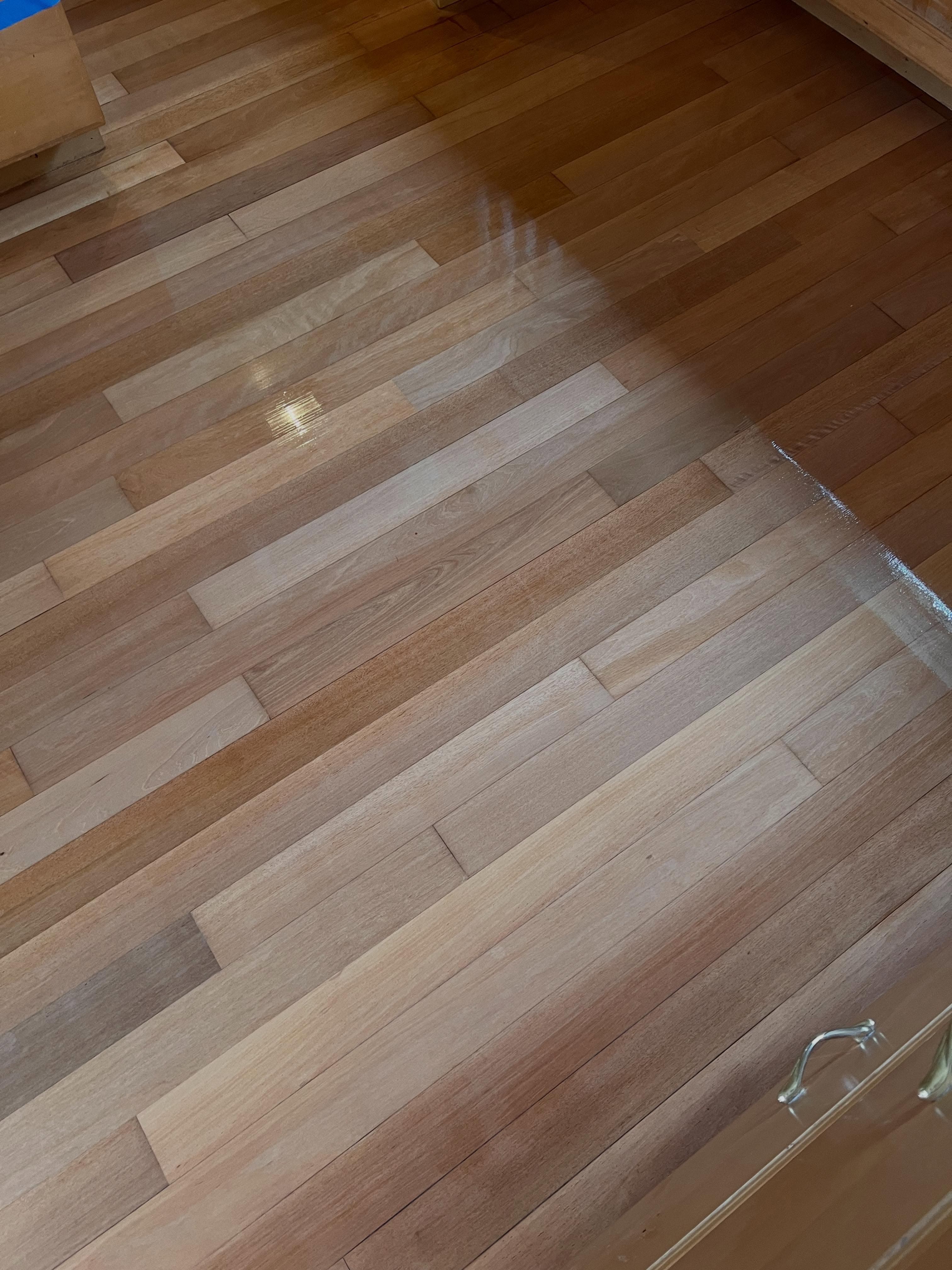Close-up of hardwood flooring planks showing grain pattern, finish, and board layout